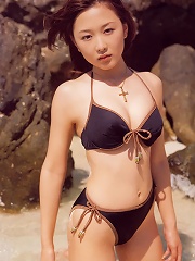 Stunning asian beauty having fun at the beach in her bikini
